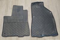 Driver and passenger front floor mats showing Toyota branding and tread