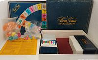Box lid, folded game board, card boxes, bagged playing pieces, dice
