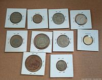 Ten coins in flips spread out on surface