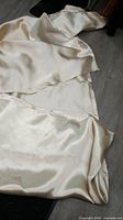 Folded cream fiberglass blanket on floor