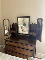 Full view of dresser showing drawers and attached tri-fold mirror