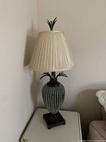 Lamp unlit showing shade, crystal bead body, and finial