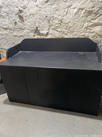 front and side view of black painted storage chest