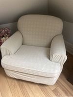 Front view of armchair with cream slipcover