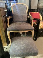 Chair with lumbar pillow and ottoman displaying overall set