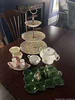 Full lot on dining table showing all five serving pieces