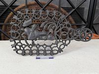Front view of cast iron trivet showing design and feet