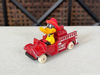 Overall view of red diecast fire truck with Daffy Duck driver