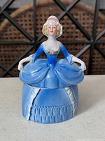 Front view of porcelain dresser doll trinket box with lid on