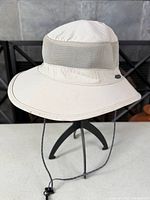 Side/front view of Kühl boonie hat showing mesh panel, brim and chin strap