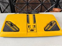 Top view of yellow Magnavox Odyssey 300 console showing paddle controllers and graphics
