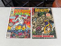 Both comic books side by side in sleeves