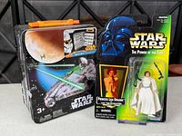 Front view of sealed Leia figure and decorated metal tin