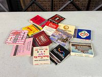 Group of vintage promotional matchbooks spread on table
