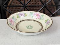 Top angled view showing floral pattern, gold rim, overall condition