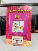 Front view of sealed blister card showing booklet and cassette