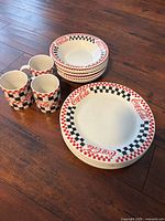 Stacked set of dinner plates, bowls and mugs showing pattern and counts