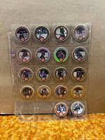 Front view of 18 Wayne Gretzky Coca-Cola pogs in plastic sleeve