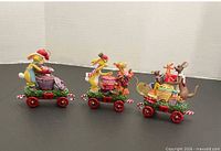 Side view of all three Pooh Christmas train ornaments