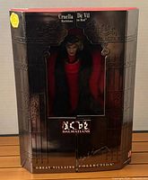 Front of unopened gatefold box showing Cruella De Vil doll inside