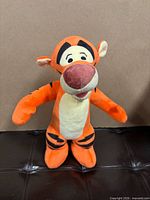 Front view of Tigger plush standing upright