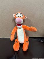 Full view of Tigger plush seated upright