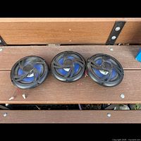 All three round blue-cone Elite coaxial car speakers on bench