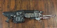Full view of Gears of War Lancer prop rifle with bayonet