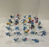 Top view of 25 assorted Smurfs PVC figurines arranged in rows