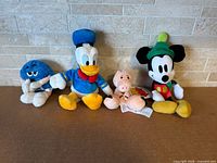 Group of four plush toys lined up