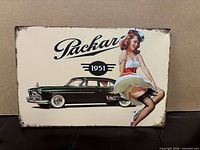 Front view of Packard 1951 tin sign showing graphics and distressed edges