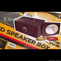 Retail packaging showing black carpeted speaker box for 6×9 driver