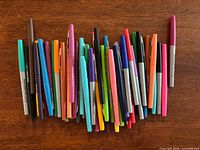 Pile of assorted Paper Mate pens showing variety of colors