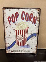 Front view of metal tin sign showing full design and distressed finish