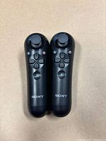 Front view of both controllers showing buttons and Sony logos