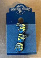 Front view of Minions enamel pin on backing card