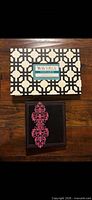 Retail box with geometric pattern and album showing embroidered cover