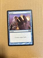 Front of Cancel card showing artwork, mana cost, set symbol M14, and wear