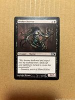 Front of Nether Horror card showing artwork, title, mana cost, type, flavour text, power/toughness, set code M11