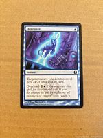 Front view of Downsize card showing artwork, title, mana cost, text box, artist name