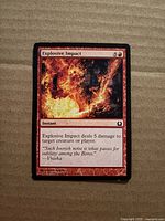 Front of Explosive Impact card showing title, artwork, mana cost, text box