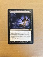 Front of Monomania card showing artwork, text, set symbol
