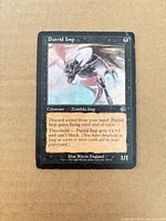 Front of Putrid Imp card showing artwork, text, set symbol and visible edge wear