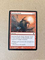 Front of Spitting Earth card showing artwork, mana cost, text box