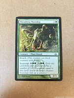 Front of Thrashing Mossdog card showing art, text, mana cost, power/toughness