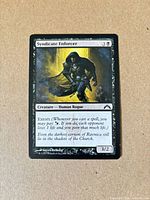 Front of Syndicate Enforcer card displaying artwork, mana cost, text, and condition