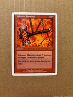 Front of Volcanic Hammer card showing artwork, mana cost, rules text and Seventh Edition set symbol