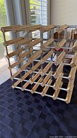 Front angled view showing 5×5 lattice of wood slats and galvanized steel braces
