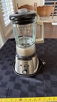 Full view of blender with glass pitcher, lid, base and cord