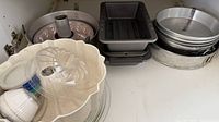 Cupboard view with Bundt pans, loaf pans, round cake pans, springform, plastic mold